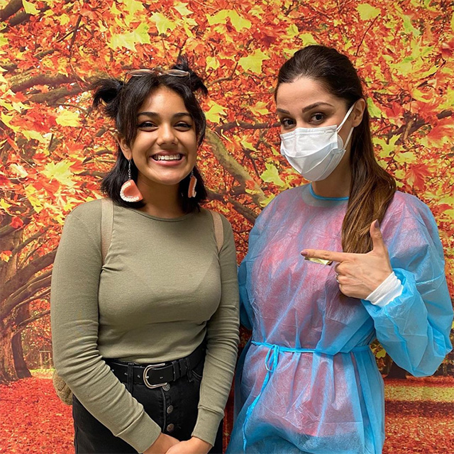A woman smiling with her dentist.