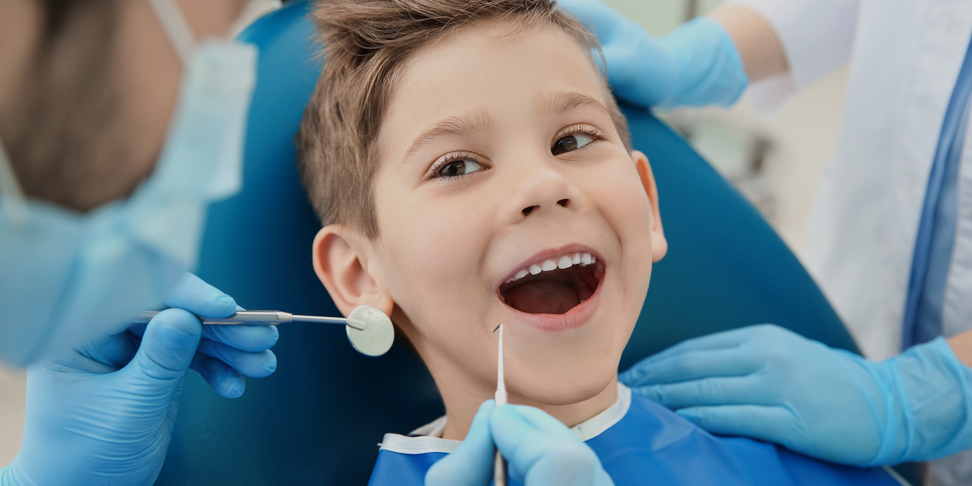 A dentist working with a child patient.